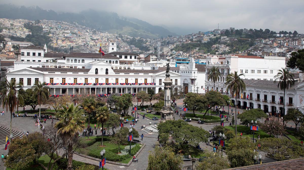 Quito Large white building in Quito with landscape behind it